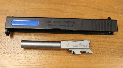 The Glock slides are clearly marked, and the barrel has modifications to prevent live ammunition being fired.