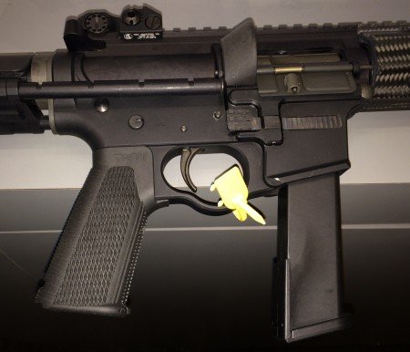 The M5 uses Glock magazines, has a Troy Control Grip, and enlarged trigger guard and magazine release button.